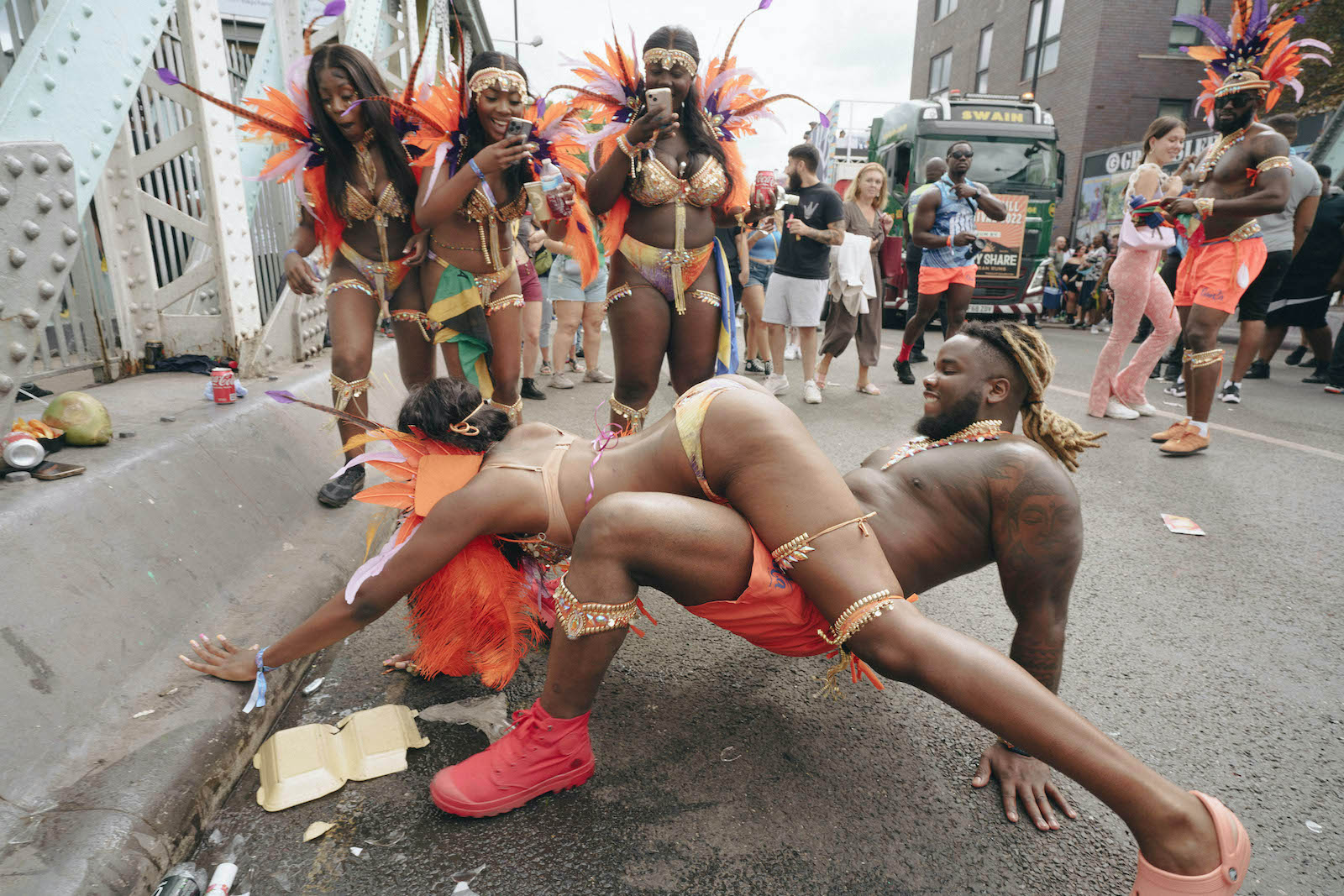 Two people dancing while three girls watch at Notting Hill Carnival 2022