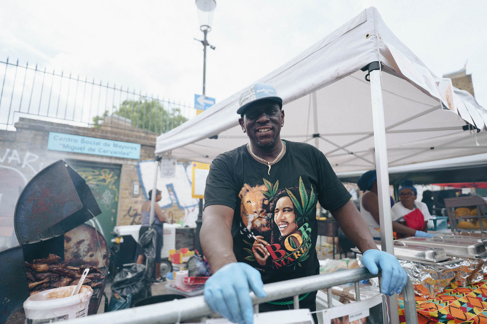 A man taking a break between cooking jerk chicken at Notting Hill Carnival 2022