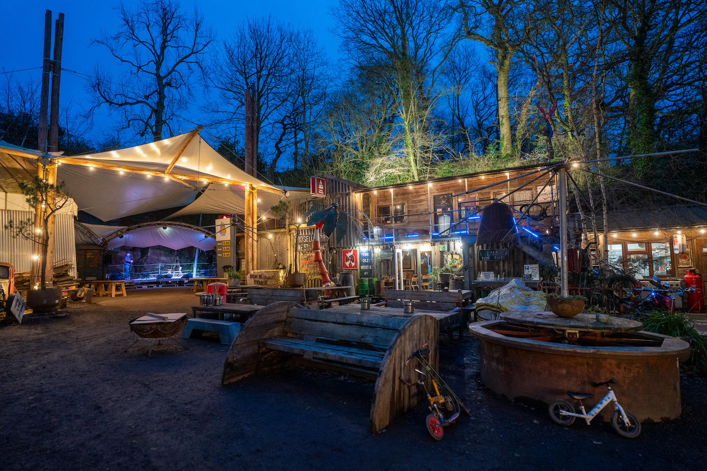 A photo of the DIY community Rockaway Park at night, surrounded by trees.